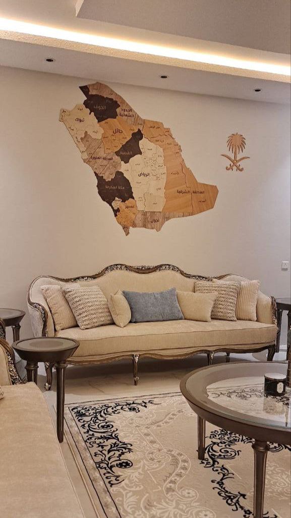 Living room with beige sofa, decorative pillows, and saudi arabia wall map.