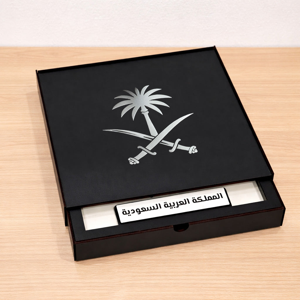 Black box with Saudi Arabia emblem and text on a wooden surface