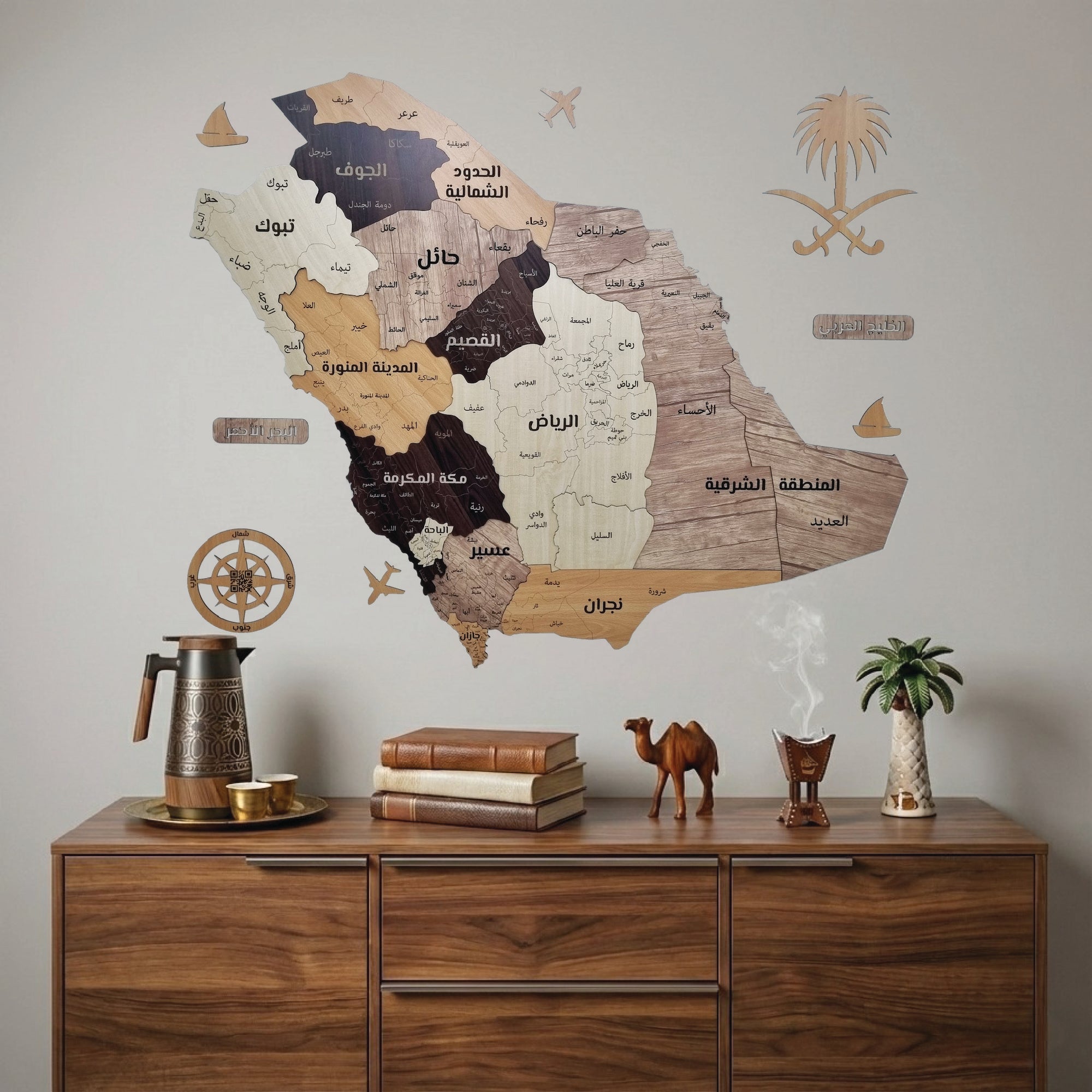ديكور حائط لخريطة للمملكة العربية السعودية على جدار فوق طاولة انتريه خشبية بها اكسسوارات سعودية.